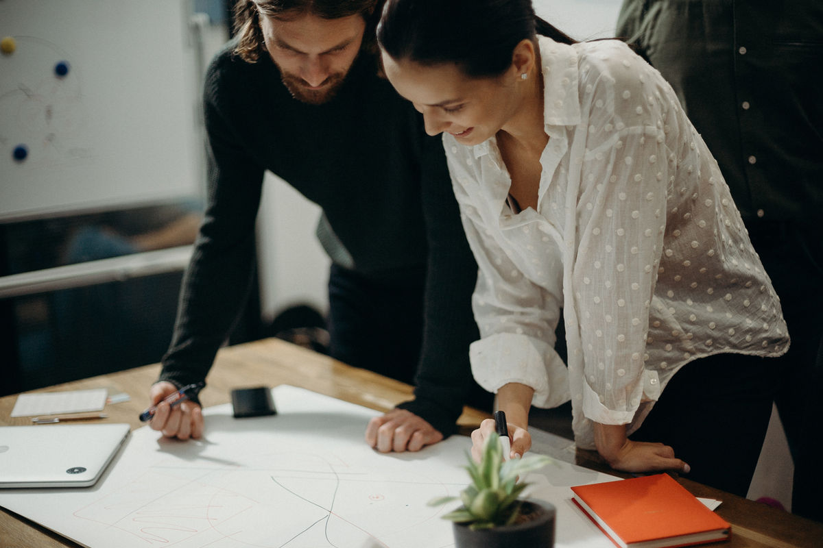 Two colleagues planning together at a table